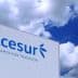 Signage displaying the Acesur logo and slogan against a blue sky with clouds. - Olive Oil Times
