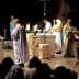 Clergy members conducting a religious ceremony at an altar with candles and decorations. - Olive Oil Times