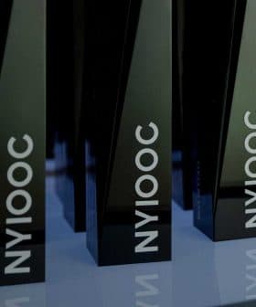 Black trophies with the inscription 'NYIOOC' displayed on a shelf. - Olive Oil Times