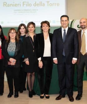 Group of individuals posing together at the Ranieri Filo della Torre event in Italy. - Olive Oil Times