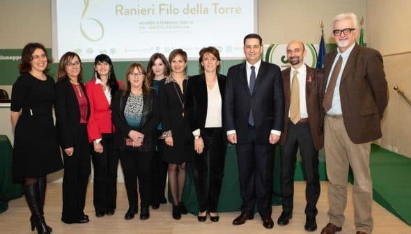 Group of individuals posing together at the Ranieri Filo della Torre event in Italy. - Olive Oil Times