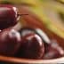 A close-up view of Kalamata olives in a bowl, showcasing their dark purple color and glossy surface. - Olive Oil Times