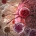 Microscopic image showing cancer cells interacting with healthy cells in a biological setting. - Olive Oil Times