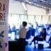 Banner for Terra Madre Salone del Gusto event with audience in the background. - Olive Oil Times