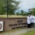 Group of five individuals in white lab coats standing in front of ULM College of Pharmacy sign. - Olive Oil Times