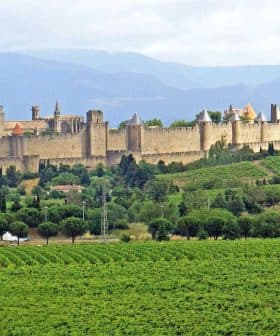 View of the medieval fortress of Carcassonne surrounded by greenery in France. - Olive Oil Times