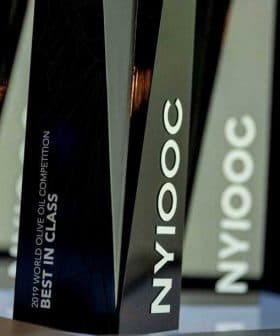 Trophies from the 2019 World Olive Oil Competition labeled 'Best in Class' and 'NYIOOC'. - Olive Oil Times