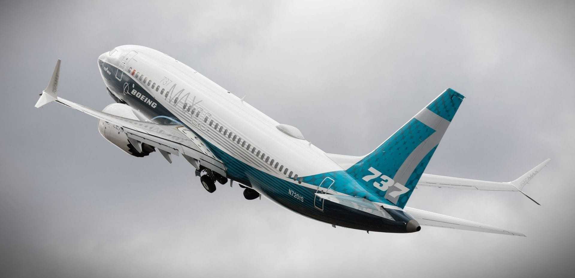 Boeing 737 aircraft taking off with a blue and white livery against a cloudy sky. - Olive Oil Times