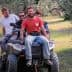 Four men riding on an all-terrain vehicle in an olive grove. - Olive Oil Times