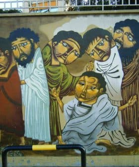 Mural featuring six figures in traditional attire with expressive faces and varied postures. - Olive Oil Times