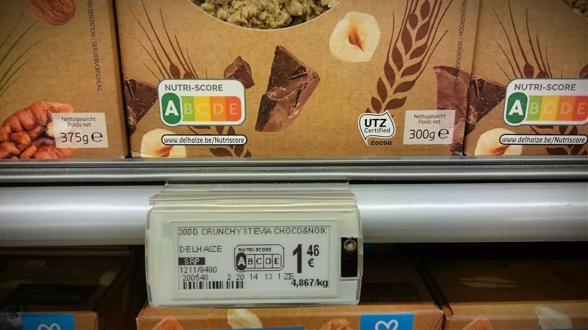 Nutri-Score label displayed on food packaging in a supermarket aisle. - Olive Oil Times