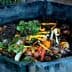 Compost bin filled with organic waste including vegetable scraps and eggshells. - Olive Oil Times