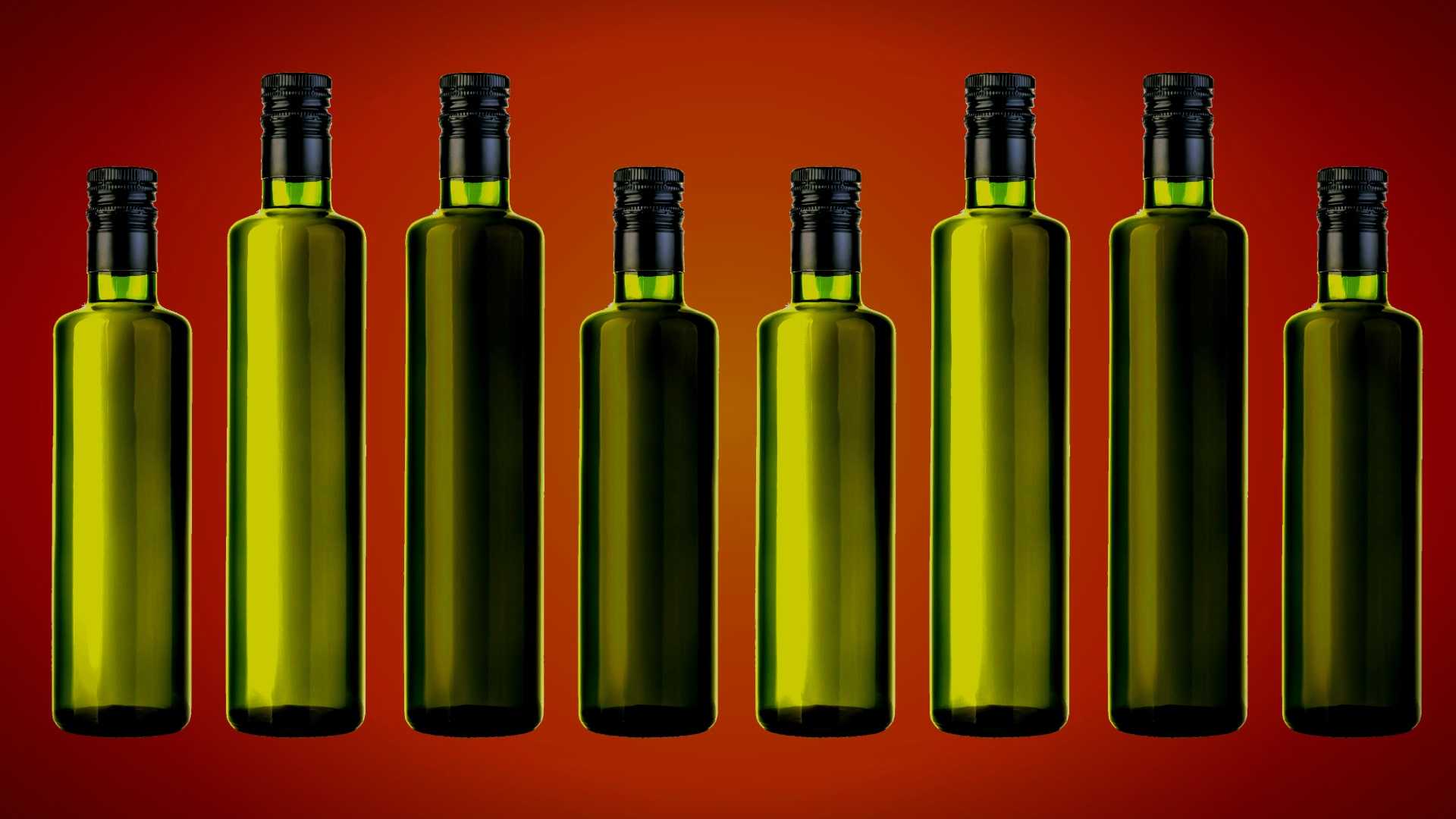 Eight green glass bottles with black caps arranged in a row against a gradient background. - Olive Oil Times