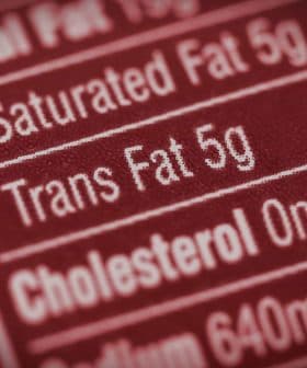 Close-up of a nutrition label indicating 5g of trans fat content. - Olive Oil Times