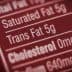 Close-up of a nutrition label indicating 5g of trans fat content. - Olive Oil Times