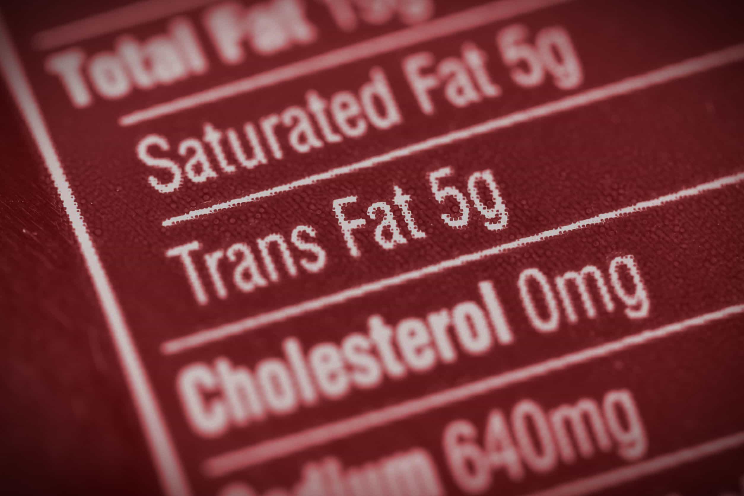 Close-up of a nutrition label indicating 5g of trans fat content. - Olive Oil Times