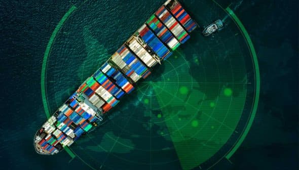 Aerial view of a cargo ship loaded with colorful containers on a radar screen. - Olive Oil Times
