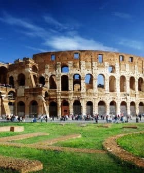 The Colosseum in Rome, an ancient amphitheater with arches and a partially intact structure. - Olive Oil Times