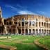 The Colosseum in Rome, an ancient amphitheater with arches and a partially intact structure. - Olive Oil Times