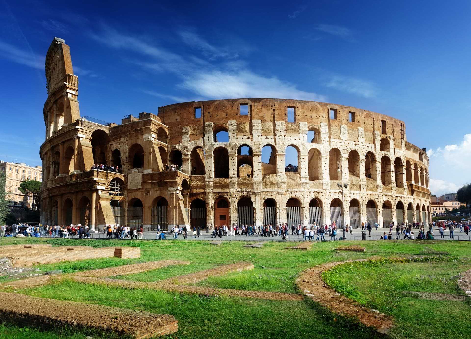 The Colosseum in Rome, an ancient amphitheater with arches and a partially intact structure. - Olive Oil Times