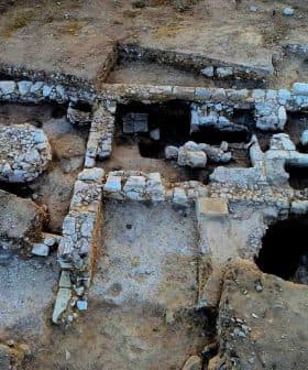 Aerial view of an archaeological site featuring stone structures and excavated areas. - Olive Oil Times
