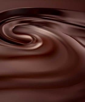 Smooth, swirling texture of dark chocolate with a glossy finish. - Olive Oil Times