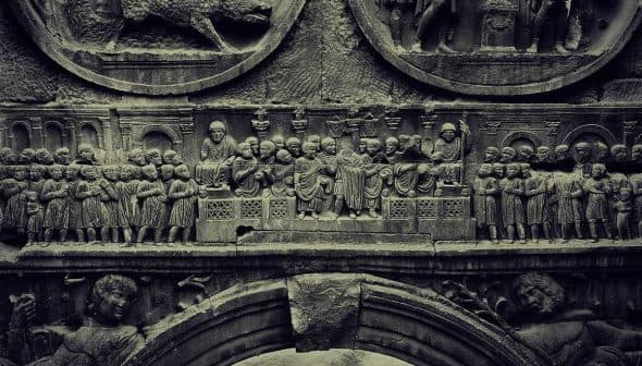 Detailed stone relief depicting historical figures and scenes in intricate carvings. - Olive Oil Times