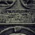 Detailed stone relief depicting historical figures and scenes in intricate carvings. - Olive Oil Times