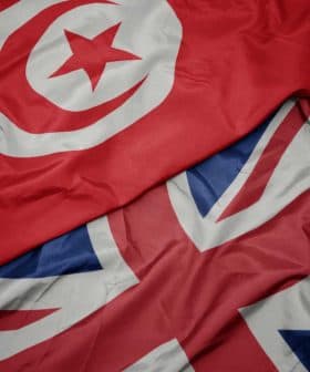 Close-up of the flags of Tunisia and the United Kingdom laid out together. - Olive Oil Times