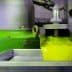 Freshly extracted olive oil flowing from a machine into a container during the production process. - Olive Oil Times