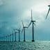 Row of offshore wind turbines standing in the ocean under a cloudy sky. - Olive Oil Times