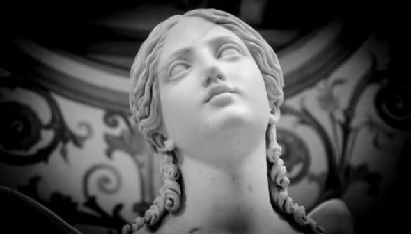 Close-up of a marble sculpture depicting a female figure with long hair and a serene expression. - Olive Oil Times