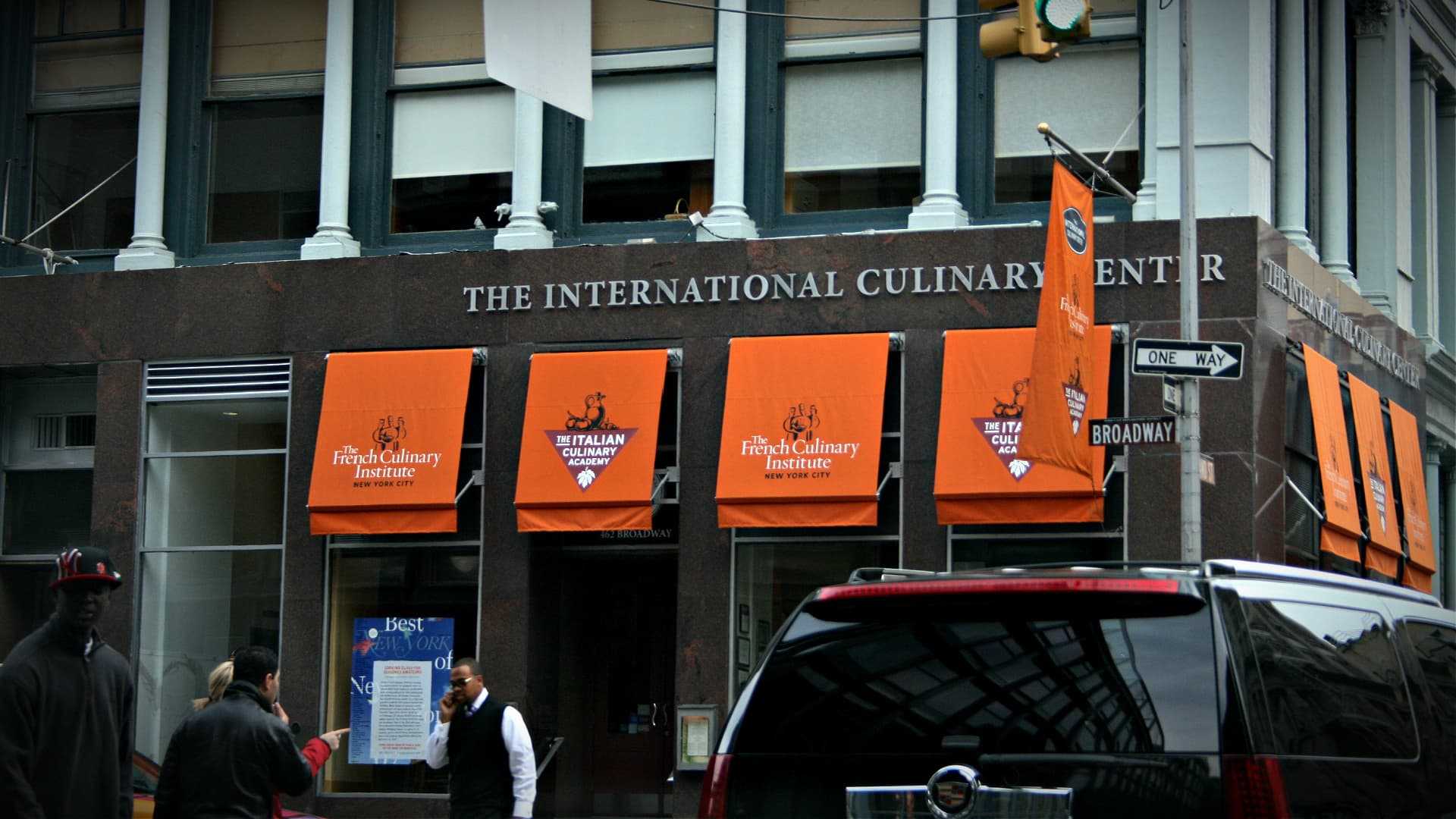 Entrance of the International Culinary Center with orange awnings and signage in New York City. - Olive Oil Times
