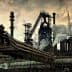 Industrial steel mill featuring large smoke stacks and pipes with visible emissions. - Olive Oil Times