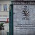 Sign of the World Trade Organization located at its headquarters with multiple languages displayed. - Olive Oil Times