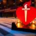 Large red heart symbol with a torch in front of a convention center entrance. - Olive Oil Times