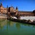 Plaza de España in Seville with a water canal and architectural structures in the background. - Olive Oil Times