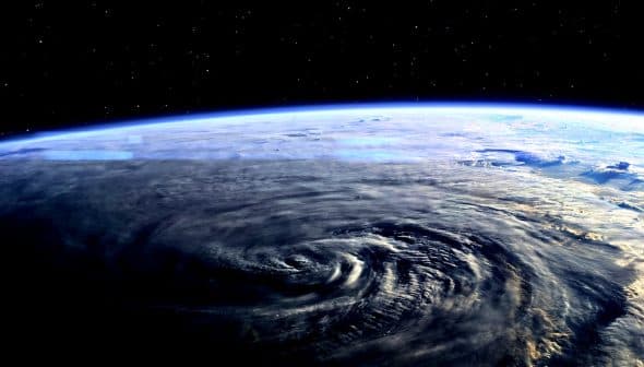 A view of Earth from space showing swirling weather patterns and the curvature of the planet. - Olive Oil Times