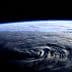 A view of Earth from space showing swirling weather patterns and the curvature of the planet. - Olive Oil Times