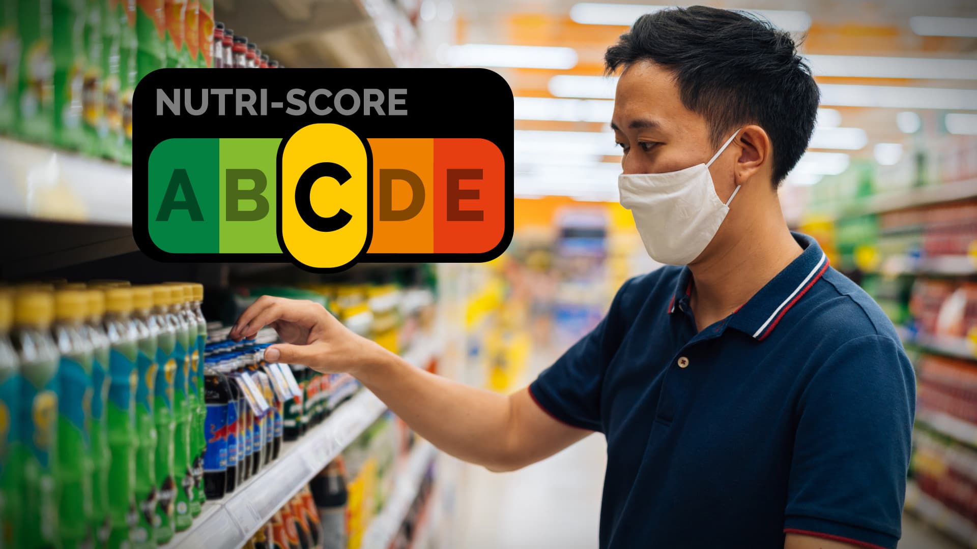 Man wearing a mask examining beverage labels on a supermarket shelf with a Nutri-Score graphic in the background. - Olive Oil Times