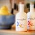 Two bottles of Brightland extra virgin olive oil with a blue bowl of lemons in the background. - Olive Oil Times