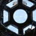 Interior view of the International Space Station's Cupola with a circular window showing Earth. - Olive Oil Times