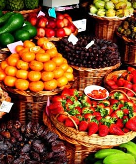 Baskets filled with various fresh fruits including oranges, strawberries, and bananas. - Olive Oil Times