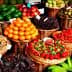 Baskets filled with various fresh fruits including oranges, strawberries, and bananas. - Olive Oil Times