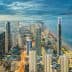 Aerial view of Gold Coast city skyline with high-rise buildings and coastline at dusk. - Olive Oil Times