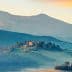 A scenic view of a Tuscan landscape featuring rolling hills and a farmhouse on a hilltop. - Olive Oil Times