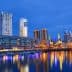 Night view of Buenos Aires cityscape with skyscrapers and waterfront reflections. - Olive Oil Times