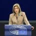 A woman speaking at a podium with the European Parliament logo during a session. - Olive Oil Times