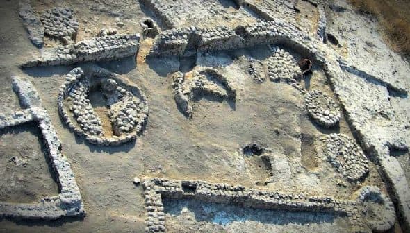 Aerial view of an archaeological site featuring various stone structures and formations. - Olive Oil Times
