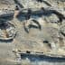 Aerial view of an archaeological site featuring various stone structures and formations. - Olive Oil Times
